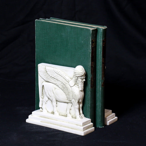 Sphinx-shaped ornate bookends with classical old world European detailing, supporting two upright hardcover books. Different Angle