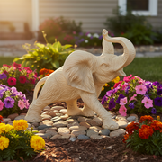 Elephant figurine with raised trunk, detailed fur texture, and classical old world European sculptural style. Side Angle