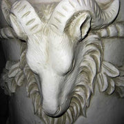 Ornate classical urn with ram head accents, laurel garland, and fluted pedestal in old world European Baroque style. Other Angle