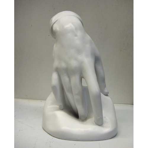 Classical Renaissance-style torso sculpture with detailed musculature and an unfinished, headless form on a smooth base. Side Angle