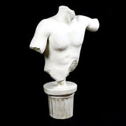 Classical Greek male torso sculpture with missing head and arms, displayed on an ornate fluted pedestal in old world European style. Other Angle