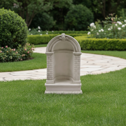 Classical old world European niche wall fountain with arched top, brick detailing, and ornate cherub accent in Baroque style. Side Angle