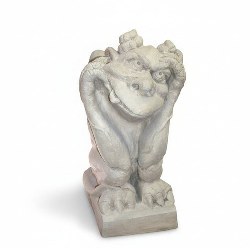 Gothic-style gargoyle statue with a whimsical expression, crouching on a pedestal with hands framing its face.