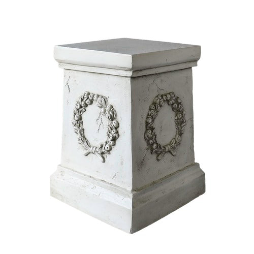 Square pedestal with ornate classical wreath relief, featuring old world European and Baroque-inspired architectural detailing. Different Angle