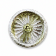 Ornate round medallion with classical old world European design, radiating fluted pattern, and central floral Baroque motif.