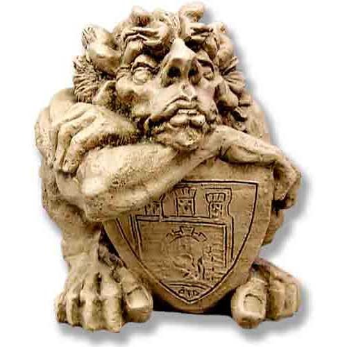 Grotesque gargoyle with expressive face and wild hair, resting on an ornate medieval shield with classical European motifs.
