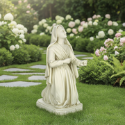 Kneeling woman statue in flowing draped robes, classical Renaissance style with serene, upward-gazing expression and ornate detailing. Side Angle