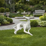Reclining greyhound sculpture with elongated limbs and elegant curves, featuring classical and old world European style. Side Angle