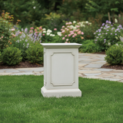 Classical pedestal with ornate panel detailing and molded edges, inspired by old world European and Renaissance architectural styles. Side Angle