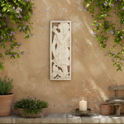 Classical relief panel featuring a nude figure playing panpipes amid ornate floral motifs in an old world European style. Side Angle