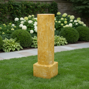 Classical Greek-style pedestal column with a square base and smooth, cylindrical shaft, featuring an old world European finish. Side Angle