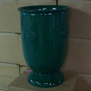 Ornate urn with classical old world European design, featuring embossed medallion details and a flared pedestal base. Side Angle