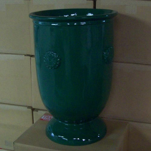 Ornate urn with classical old world European design, featuring embossed medallion details and a flared pedestal base. Side Angle