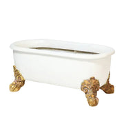 Clawfoot bathtub with ornate, Baroque-style gold feet and classical old world European design. Side View