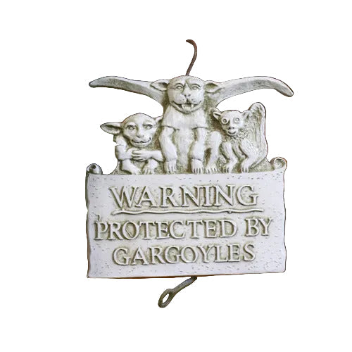 Gothic-style plaque with three ornate gargoyles perched above raised classical lettering reading “Warning Protected by Gargoyles”.