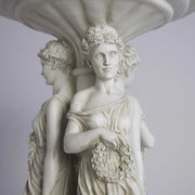 Classical pedestal table featuring three ornate, draped female figures in an old world European, Renaissance-inspired design. Different Angle