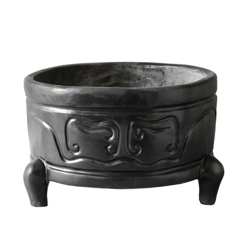 Tripod incense burner with ornate, old world European motifs and classical curved patterns, featuring three sturdy legs and raised reliefs. Side Angle