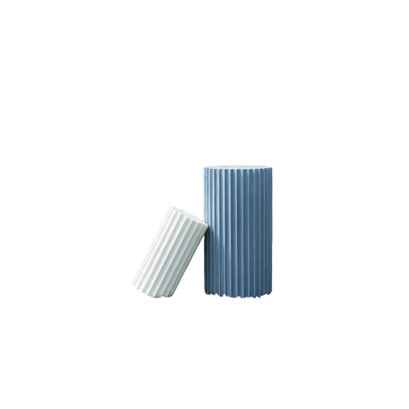 Fluted cylindrical vessels with classical Greek-inspired vertical ridges, one upright and one leaning beside it. Side View