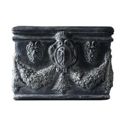 Square planter with ornate Baroque reliefs, classical shield motifs, and intricate garland detailing in old world European style. Side Angle