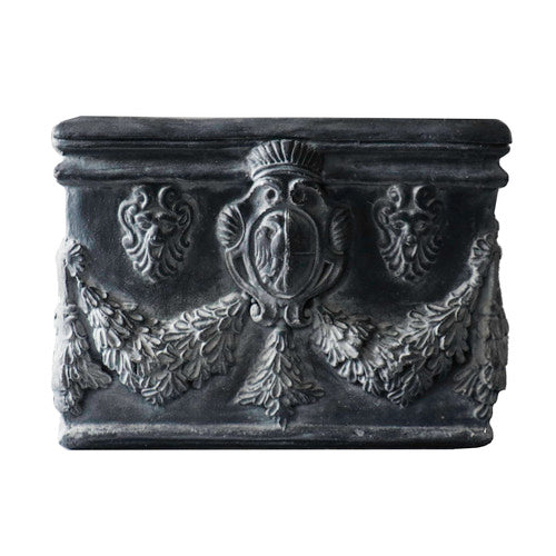 Square planter with ornate Baroque reliefs, classical shield motifs, and intricate garland detailing in old world European style. Side Angle