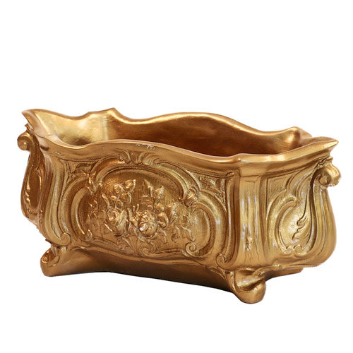 Ornate Baroque planter with intricate floral relief and curved, classical old world European design elements. Side View