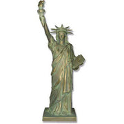 Statue of Liberty replica with classical draped robe, ornate crown, and raised torch in neoclassical architectural style. Side View