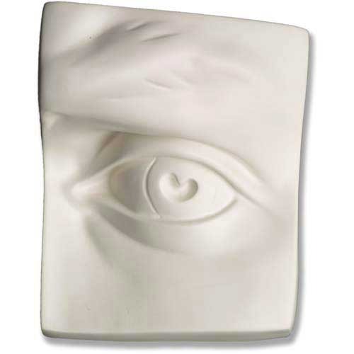 Classical Renaissance-style sculpted relief of a human eye with detailed brow and eyelid on a rectangular plaque.
