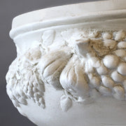 Ornate classical pedestal bowl with Baroque fruit and floral relief, featuring old world European decorative detailing. Side Angle
