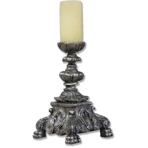 Ornate Baroque-style candle holder with intricate scrollwork, classical motifs, and a sculpted pedestal base supporting a pillar candle.