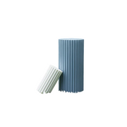 Fluted column-inspired candle set with classical Greek architectural style and vertical grooves, one upright and one tilted. Side View