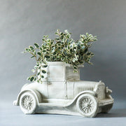 Vintage car sculpture with old world European charm, featuring ornate classical detailing and a nostalgic, early 20th-century design. Other Angle
