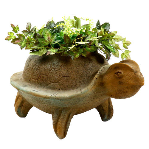 Turtle-shaped planter with ornate, old world European detailing and Renaissance-inspired sculptural features, filled with lush greenery.