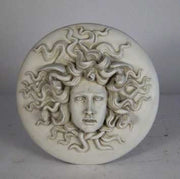 Medusa head relief with intricate serpentine hair, classical Greek style, ornate detailing, and dramatic facial expression. Different Angle