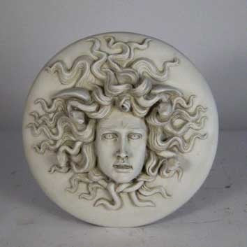 Medusa head relief with intricate serpentine hair, classical Greek style, ornate detailing, and dramatic facial expression. Different Angle
