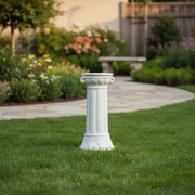 Classical pedestal column with fluted shaft, ornate leaf detailing, and old world European architectural style. Side Angle