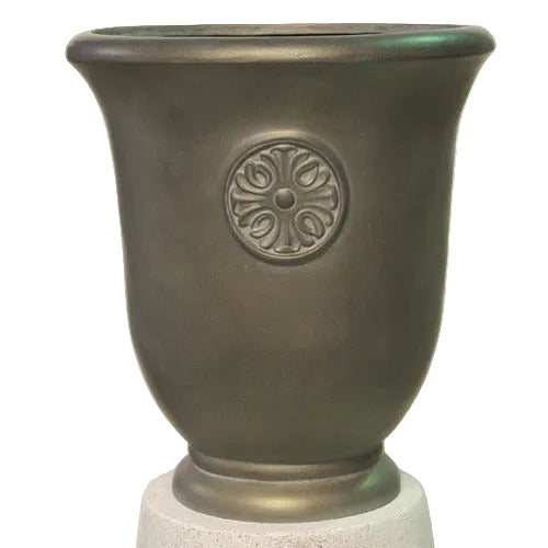 Ornate old world European urn with classical flared rim and embossed medallion featuring a Renaissance floral motif.