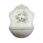 Wall fountain with ornate classical face relief, old world European style, featuring intricate Baroque and Renaissance detailing.