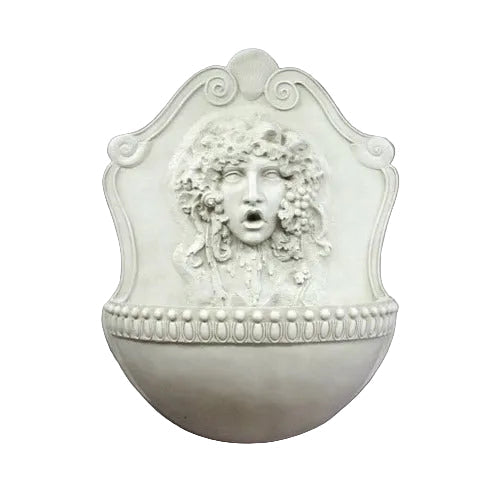 Wall fountain with ornate classical face relief, old world European style, featuring intricate Baroque and Renaissance detailing.