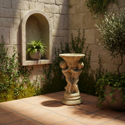 Baroque pedestal planter with ornate cherub figures supporting a fluted bowl, featuring classical old world European detailing. Side Angle