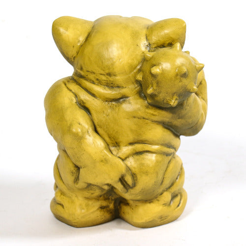 Grotesque medieval gargoyle figurine with exaggerated features, pointed ears, and club, in an old world European style. Side Angle