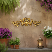 Ornate Baroque-style decorative applique with symmetrical scrollwork and classical old world European leaf motifs. Different Angle