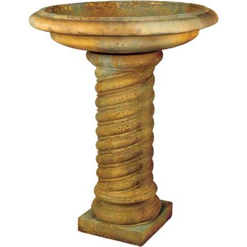 Ornate old world European bird bath with a wide basin and classical twisted column pedestal on a square base.