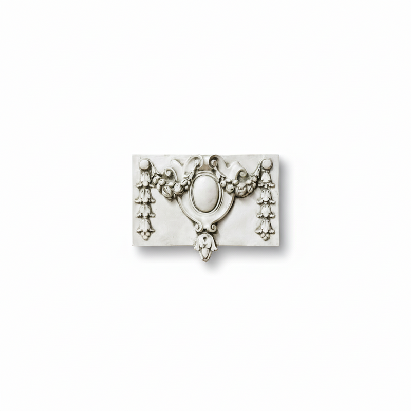 Ornate Baroque-style wall plaque with central oval medallion, floral garlands, and classical scrollwork detailing. Side View
