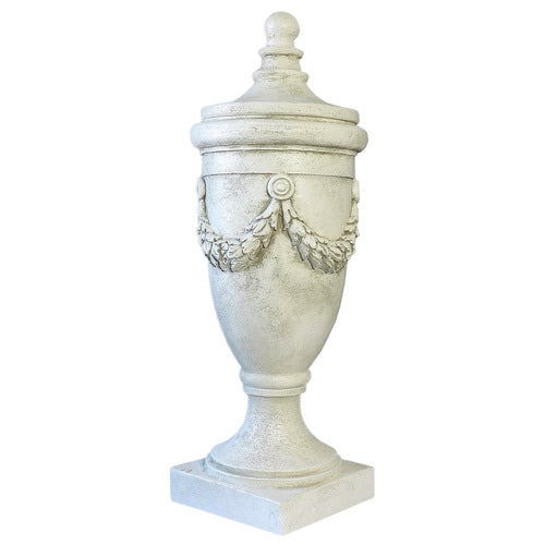Ornate classical urn with garland relief and pedestal base, featuring a detached finial lid, in old world European style. Different Angle