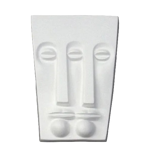 Abstract old world European wall sculpture featuring minimalist, geometric facial features with classical and modernist influences.