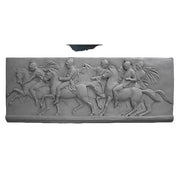 Classical Greek relief panel depicting four riders on horseback in dynamic motion, featuring detailed, ornate sculptural elements.