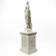 Classical European statue of a robed woman on an ornate pedestal with Renaissance and Baroque decorative reliefs. Side View