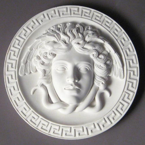 Medusa head relief with flowing serpentine hair, surrounded by a Greek key border in classical old world European style. Different Angle