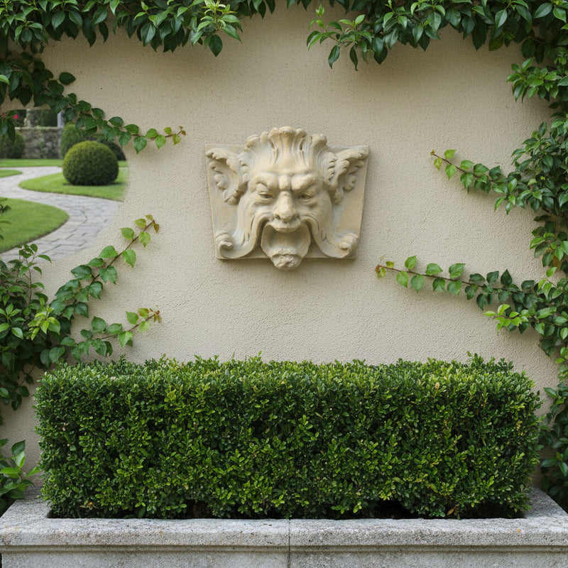 Grotesque face wall plaque with ornate Baroque detailing, classical old world European style, featuring curled mustache and pointed ears. Side Angle