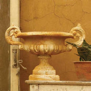 Ornate classical urn with elaborate handles and pedestal base, featuring old world European and Baroque decorative details. Side Angle